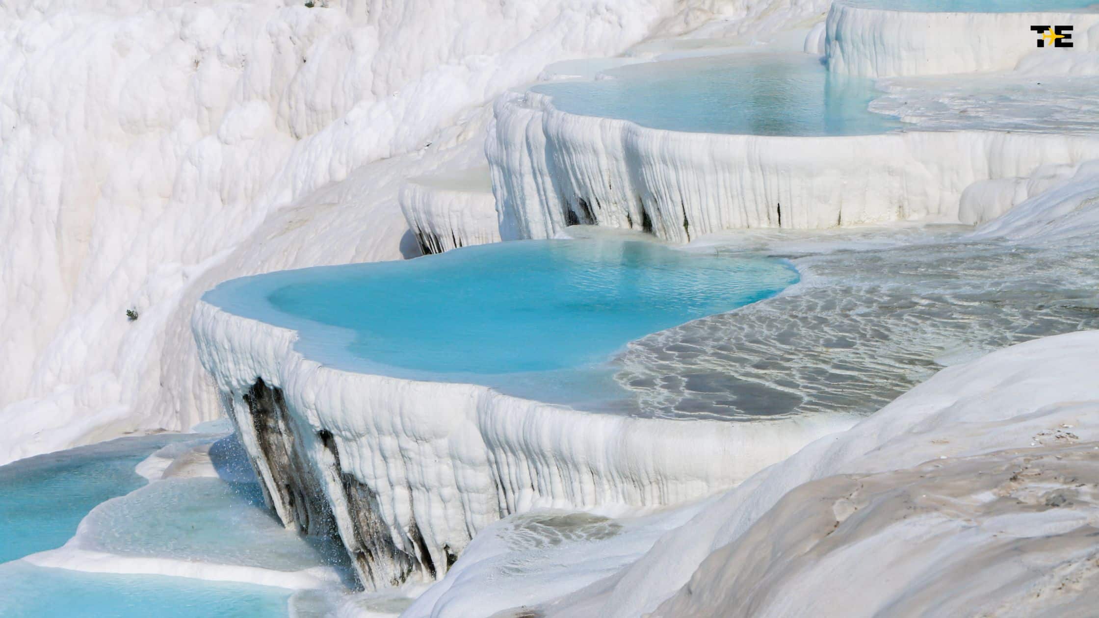 Stunning Pamukkale travertine terraces with turquoise thermal pools and unique natural formations.