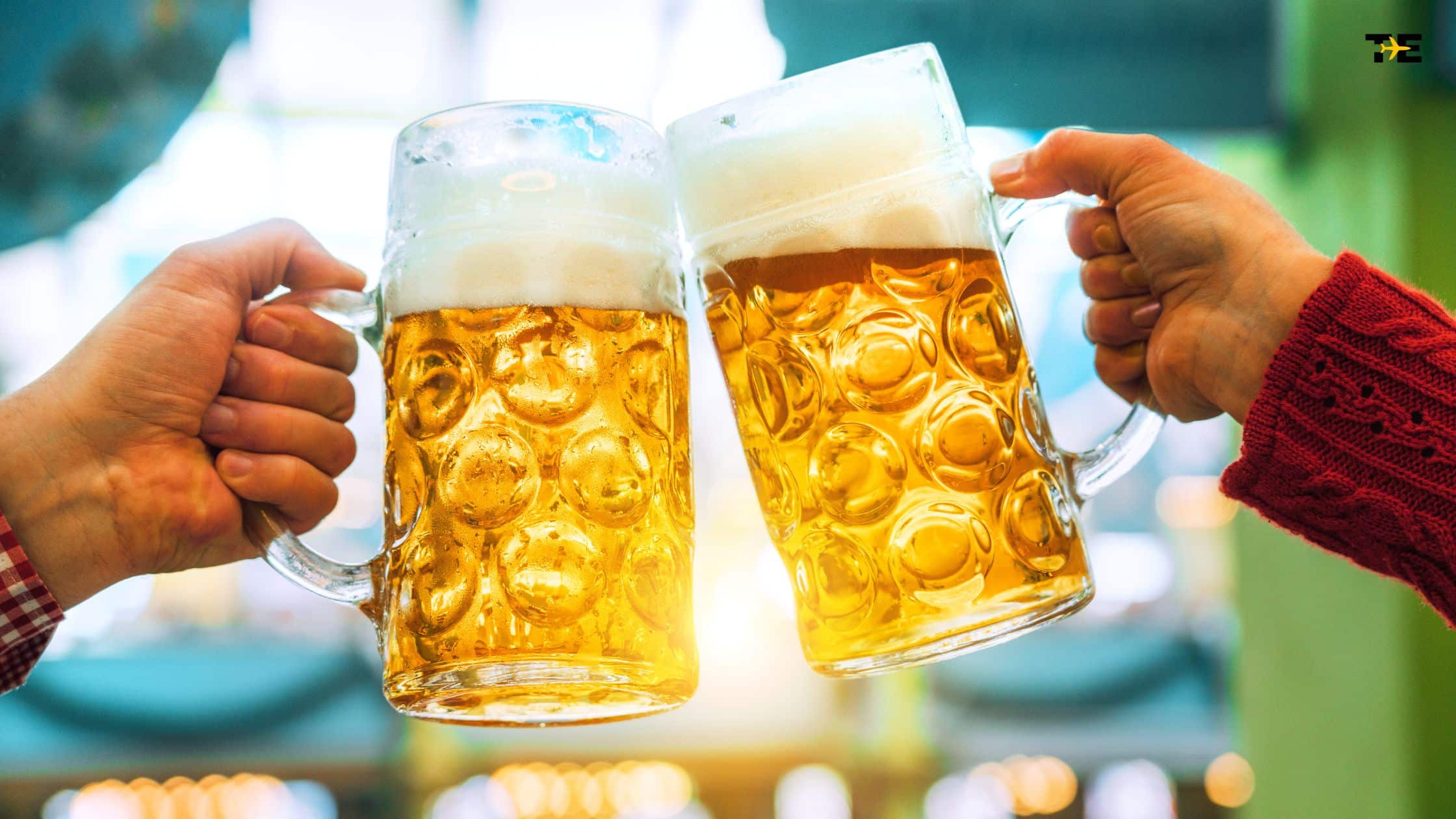 Cheers with beer mugs in a lively pub setting, celebrating friendship and good times.