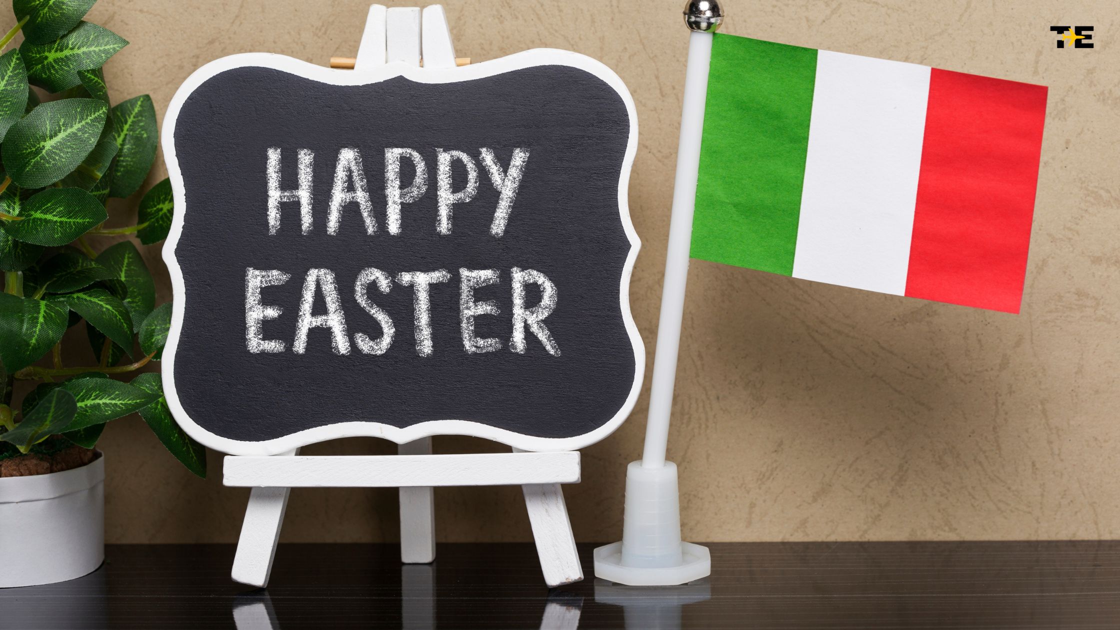 Charming Easter display with chalkboard sign, greenery, and Italian flag for festive celebrations.