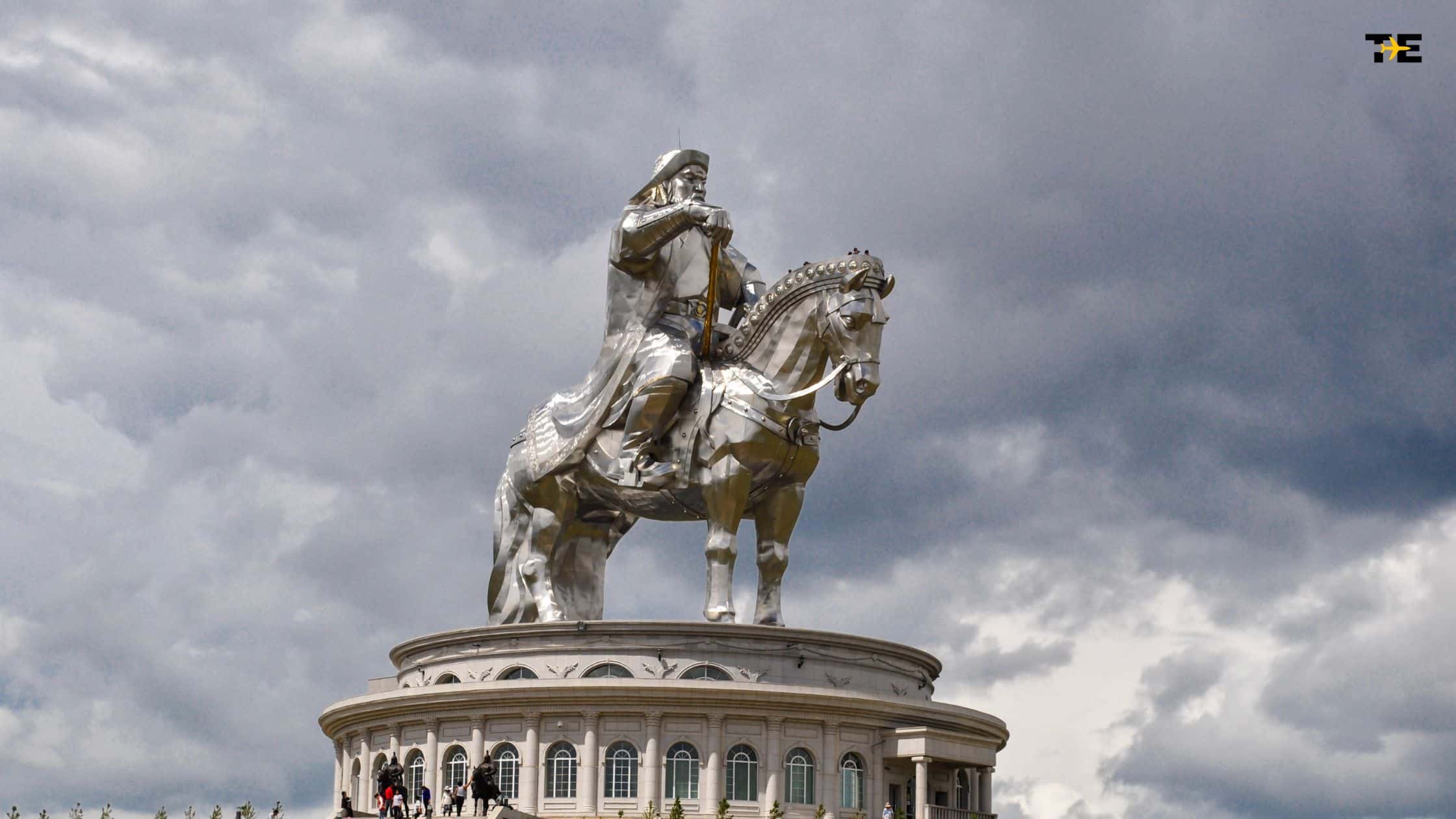 Equestrian statue of a historical figure against dramatic overcast skies, showcasing intricate craftsmanship.