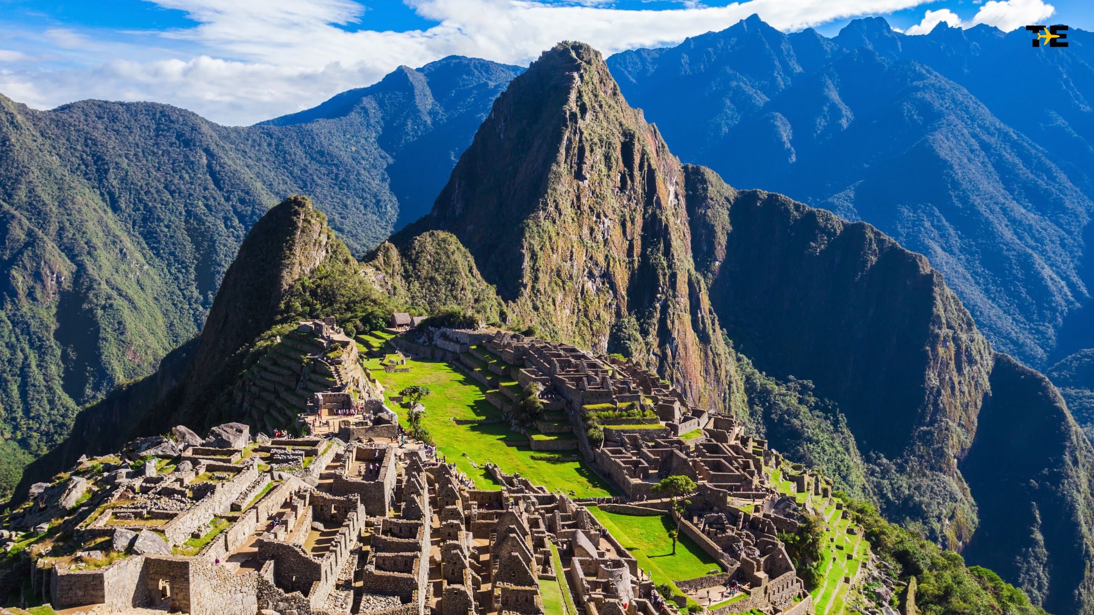 Machu Picchu ruins showcase Incan architecture amidst stunning Andes mountains and lush greenery.