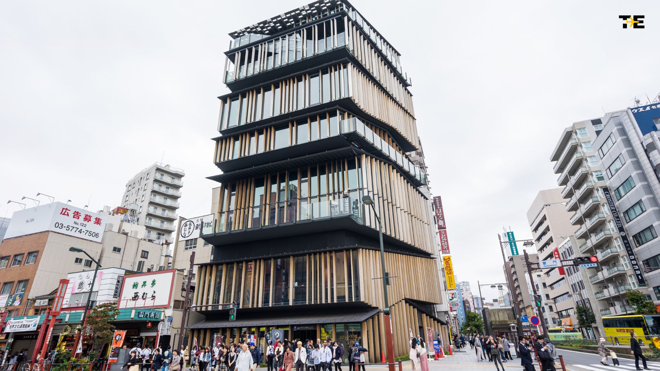 Vibrant urban scene featuring modern architecture, diverse crowd, and dynamic city life.