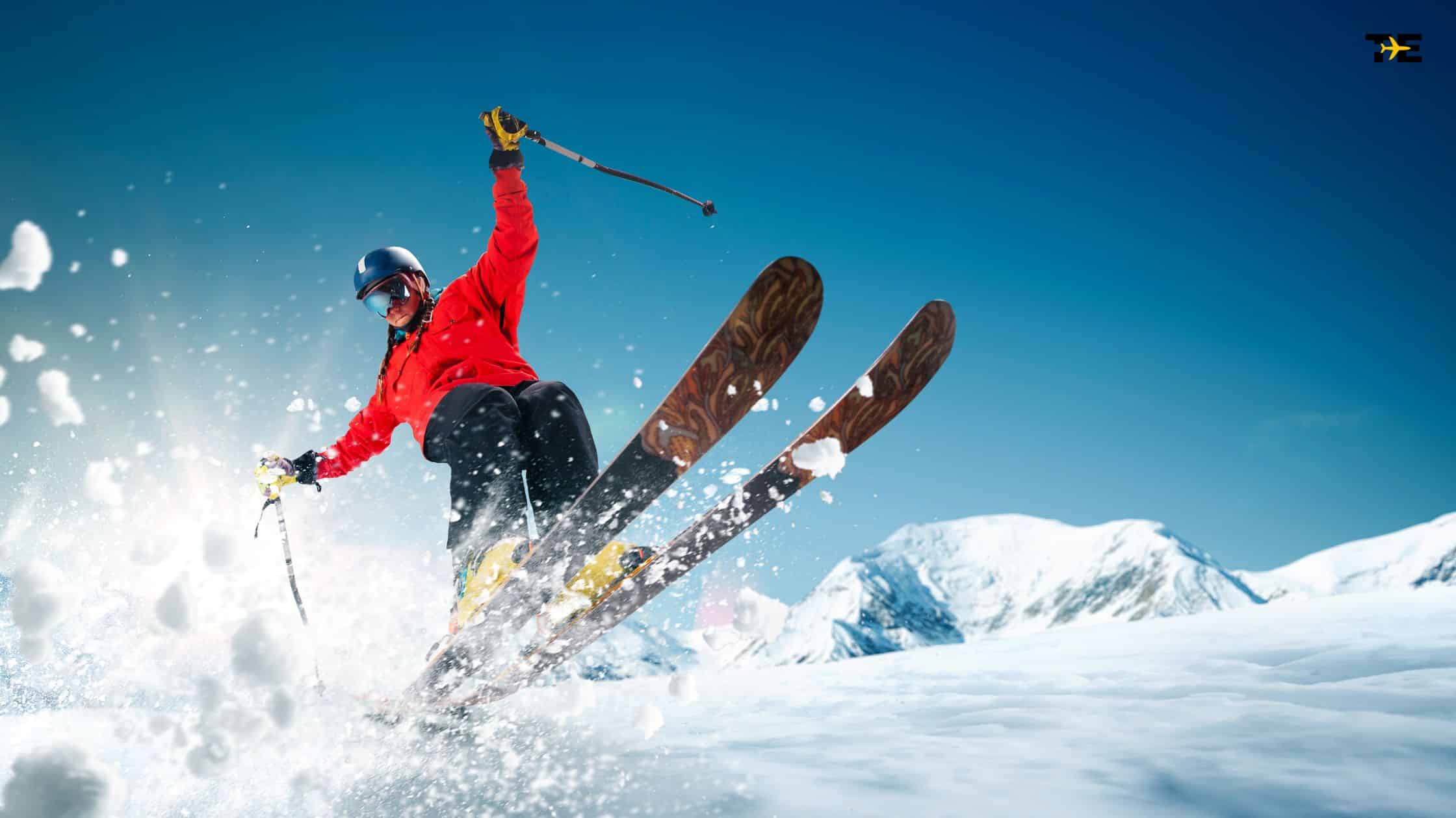 Skier in red jacket carving through fresh snow on a stunning alpine slope.