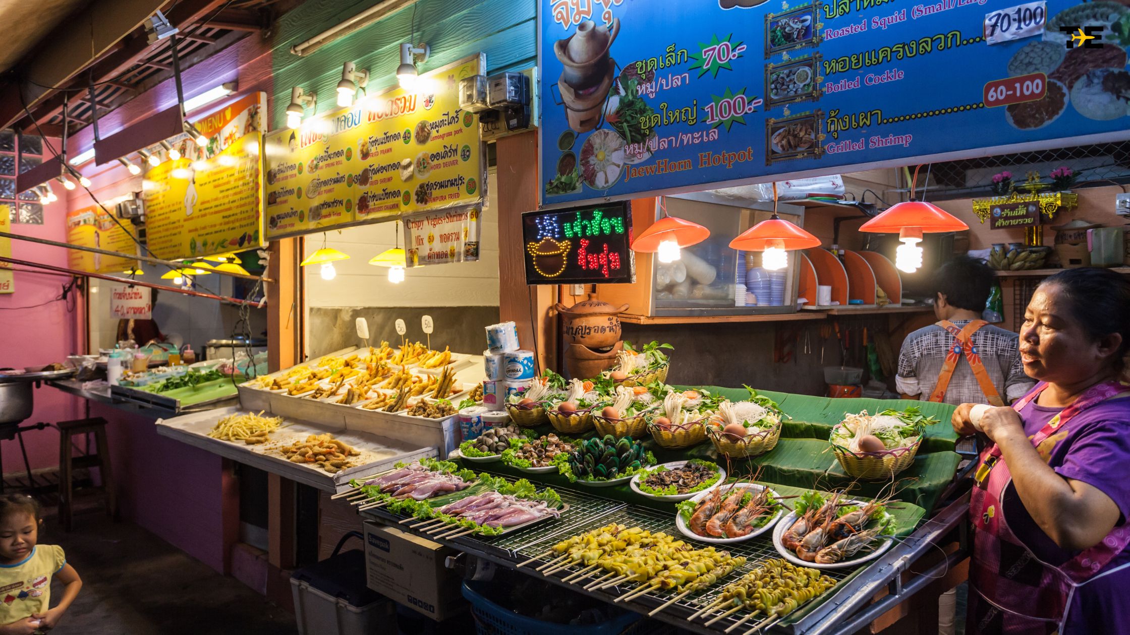 Vibrant street food scene with colorful stalls, delicious dishes, and a lively market atmosphere.